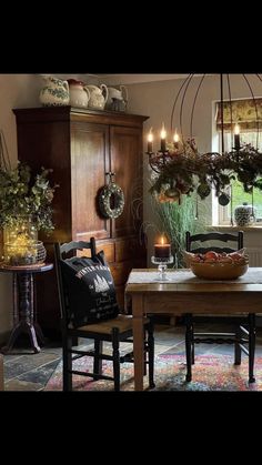 a dining room filled with lots of furniture and candles on top of the table in front of a window