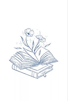 an open book sitting on top of a table next to a flower and butterfly flying over it