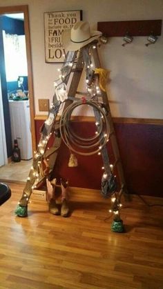 a ladder that has some lights on top of it and is decorated with christmas lights