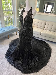 a black evening gown on display in a living room