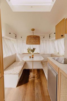 the inside of a camper with wood flooring