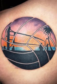 a man with a tattoo on his shoulder that has an image of a beach ball and palm trees