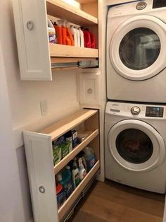 a washer and dryer in a small room next to each other with shelves