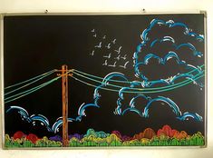 a chalk board with birds flying in the sky and power lines painted on it's side