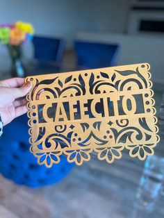 a person holding up a cutout with the word idea on it in front of a table