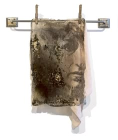 a piece of cloth hanging on a clothes line with an image of a woman's face