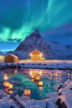 the aurora lights shine brightly in the night sky over a lake with floating lanterns on it