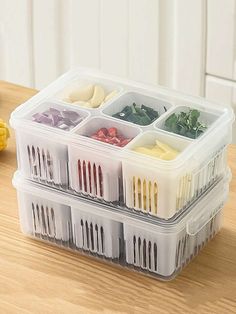 a plastic container filled with different types of food on top of a wooden table next to bananas