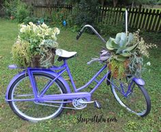 a blue bicycle with flowers in the basket