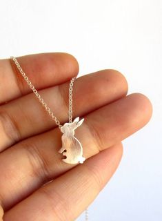 A cute handmade little rabbit necklace for bunny lovers or to remember a loving pet. Handmade with High quality Sterling silver and Sterling silver chain. - This is a perfect gift for pet and bunny lovers or a special gift to remember the memories shared with a loving pet. - The necklace in the pictures is 16'' size. - Available in sizes 15'' to 30''. - CHECK YOUR SIZE measuring your neck with a string or yarn. - Your necklace arrives beautifully packaged and is ready to gift. - One necklace. MA Cute Charm Necklaces For Gifts, Cute Hypoallergenic Charm Necklaces For Gifts, Cute Hypoallergenic Charm Necklace For Gift, Cute Handmade Sterling Silver Necklaces, Cute Round Pendant Charm Necklaces As Gifts, Cute Round Pendant Charm Necklace For Gifts, Cute Round Pendant Charm Necklaces For Gifts, Cute Handmade Easter Jewelry, Personalized Jewelry For Easter Gifts