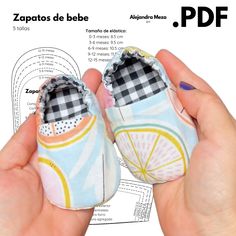 someone is holding up their baby shoes to show off the pattern on them, which has been cut into half