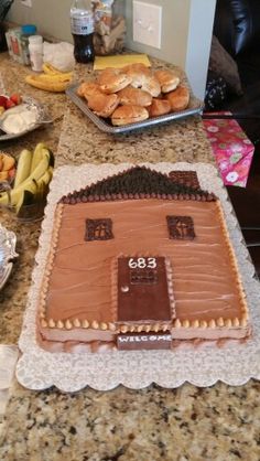 a cake that is on top of a table with other foods and desserts around it