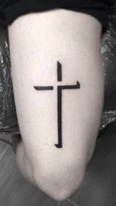 a person with a cross tattoo on their leg