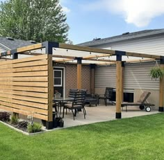 an outdoor patio with wooden pergoline and chairs