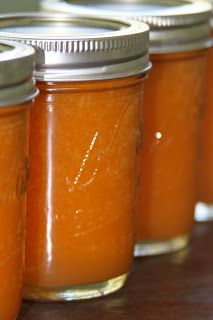 several jars filled with orange liquid sitting on top of a table