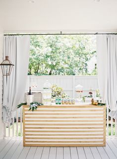 an outdoor bar is set up on the porch for guests to enjoy their food and drink