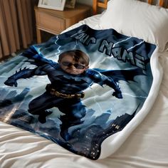 a bed with a batman blanket on top of it