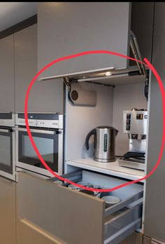 a kitchen with an oven, microwave and coffee maker in it's cupboards