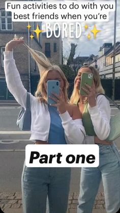 two women standing next to each other holding up their cell phones in front of them