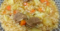 a bowl filled with meat and rice on top of a table