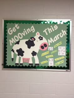 a sign that says get moving this march with a cow in the center and words on it