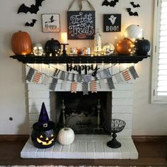 a fireplace decorated for halloween with pumpkins and decorations