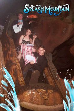 two people are riding on a roller coaster at the amusement park with splash mountain in the background