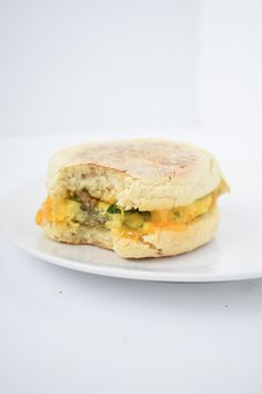 an egg and cheese sandwich on a white plate