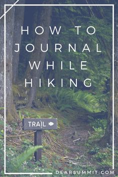 a trail sign with the words how to journal while hiking in front of trees and ferns