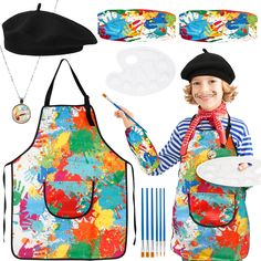 a child wearing an apron and hat with paint splattered on it, holding a brush