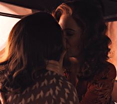 two women are sharing a kiss on the bus