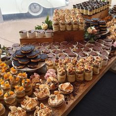 an assortment of desserts and pastries displayed on a table