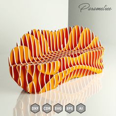 an orange and white paper sculpture sitting on top of a table