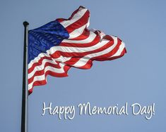 an american flag blowing in the wind with a happy memorial day message