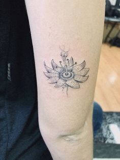 a woman's arm with a flower tattoo on it