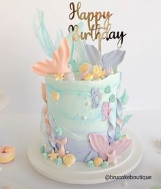 a birthday cake decorated with sea shells and stars