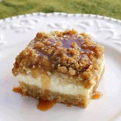 a piece of cake on a plate with caramel sauce drizzled over it