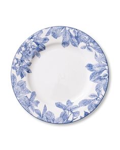 an empty blue and white plate with leaves on the rim, against a white background