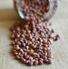 a jar filled with beans sitting on top of a table