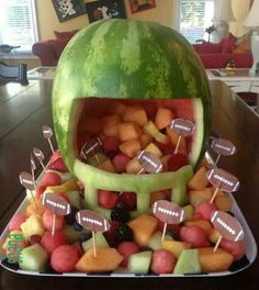 a watermelon shaped like a football helmet filled with fruit