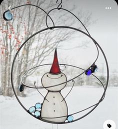 a wind chime with a snowman wearing a red hat