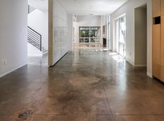 an empty room with white walls and wooden doors on either side of the door is a staircase