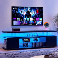 a flat screen tv sitting on top of a entertainment center