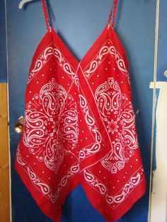 a red bandana hanging on a blue wall