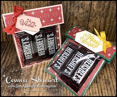 two small boxes with chocolates in them on top of a wooden table next to each other