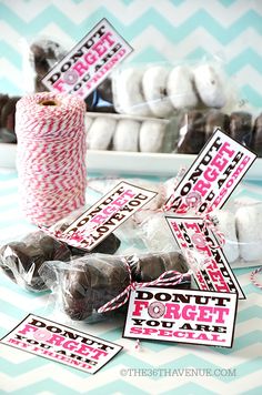 candy bar wrappers with pink and black printables sitting on top of a table