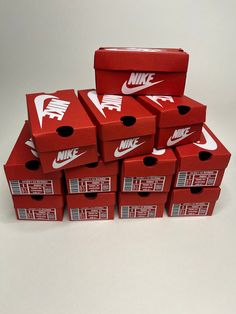 six red nike boxes stacked on top of each other