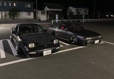 two cars parked next to each other in a parking lot