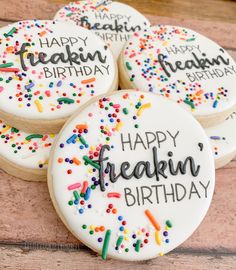 four decorated cookies with happy freakin'birthday written on them