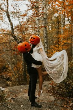 a bride and groom dressed up as jack - o'- lanterns